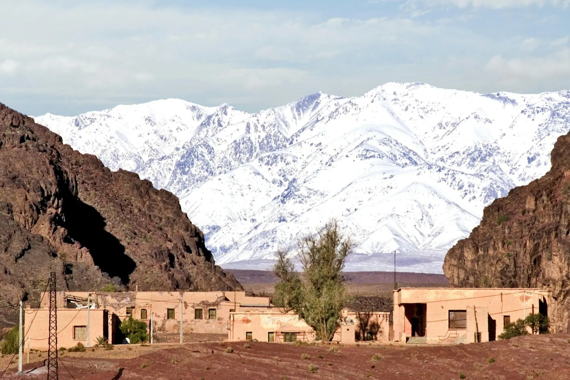Ouarzazate Desert village with snowy Atlas Mountains, Morocco