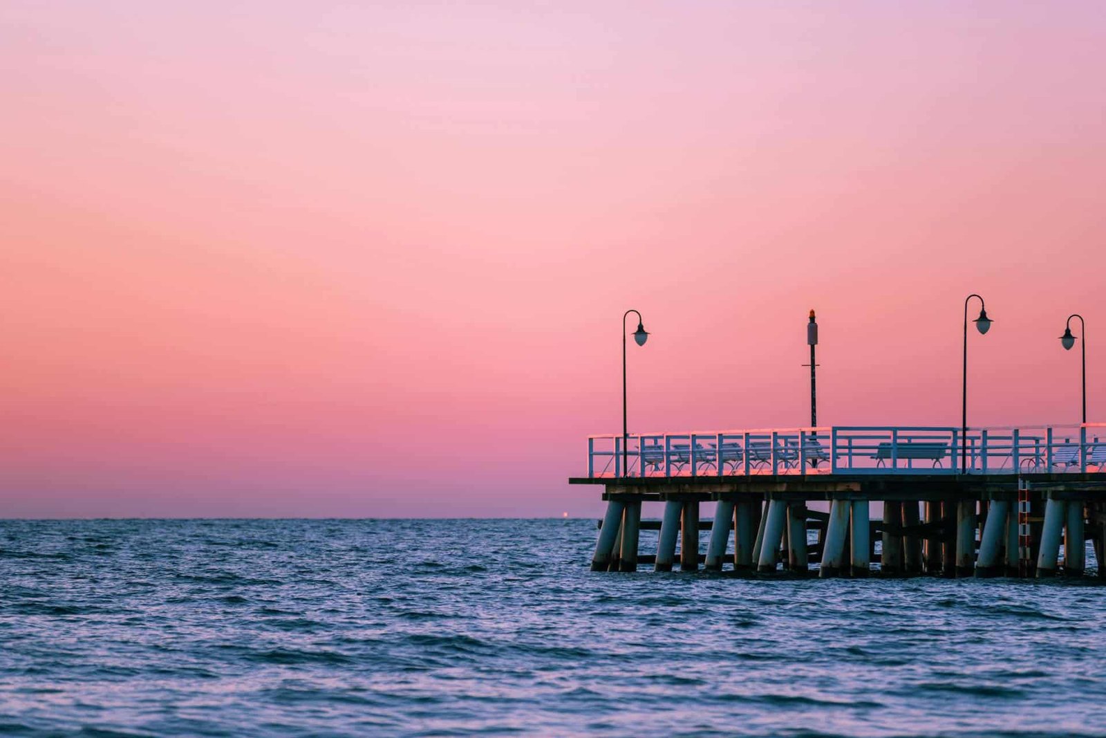 Pink Sky Over Empty Pier at Dusk, showing the Orłowo Pier in Gdynia, Poland