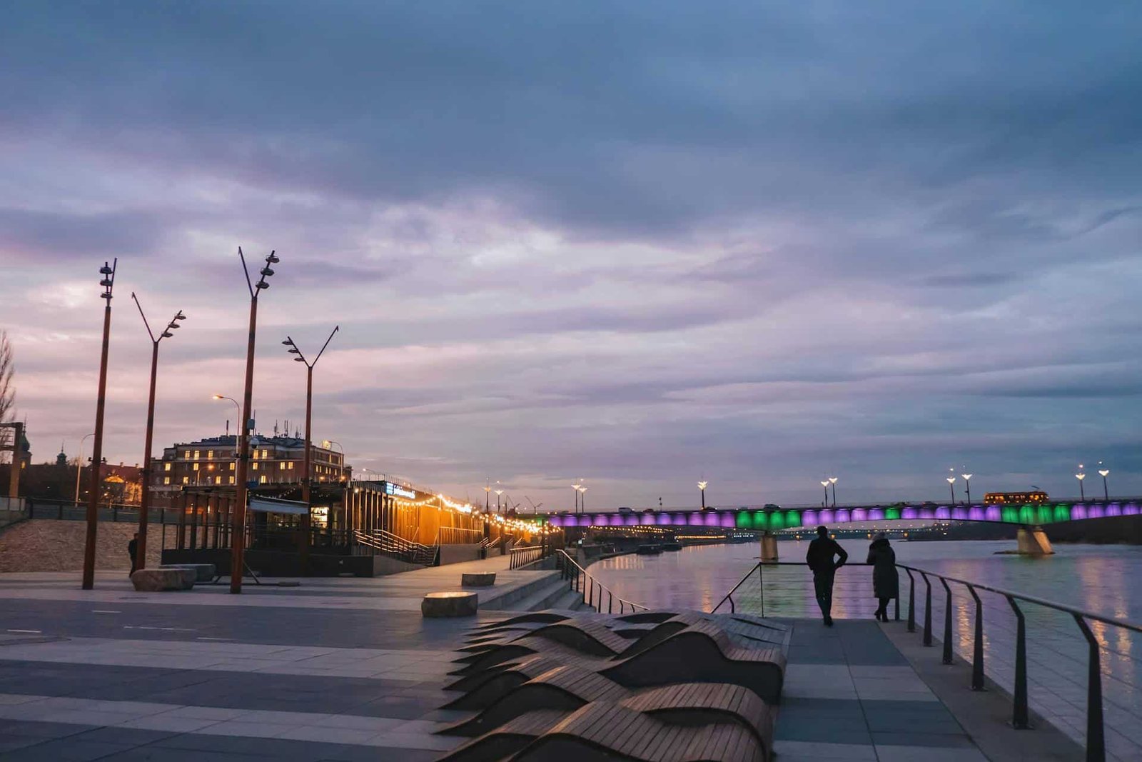 The Vistula River Promenade at Night, with colorful bridge in Warsaw, Poland